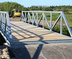Stibro i Fårup. Cykel og gangbroen er fremstillet i solidt galvaniserset stål med betonanslag i hver ende. Uderumsinventar BY BANG